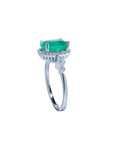 14K white gold halo ring with a deep green oval-cut emerald and sparkling diamond accents.