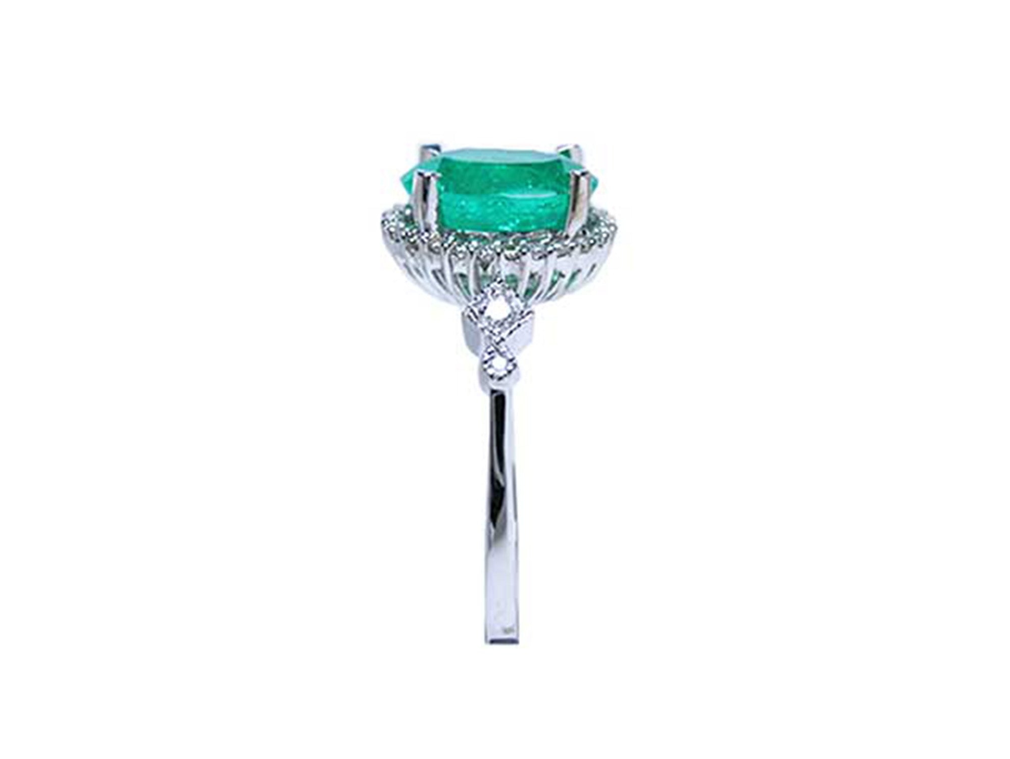 Emerald ring with diamond accents on a white background