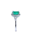 14K white gold halo ring with a 2.02 ct. oval-cut deep green emerald and natural diamonds.