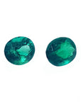 Oval cut matched pair loose natural emeralds 1.60 ct. front right side table and crown view