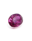 1.31 ct. oval-cut natural Burma ruby gemstone with vivid red and purple hues.
