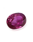 1.31 ct. oval-cut natural Burma ruby gemstone with vivid red and purple hues.