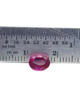 1.31 ct. oval-cut natural Burma ruby gemstone with vivid red hue, measured by a ruler.