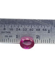 1.31 ct. oval-cut natural Burma ruby gemstone with vivid red hue, measured by a ruler.