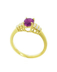 14k yellow gold ring with a deep red oval ruby and sparkling side diamonds.