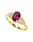 14k yellow gold ring with a deep red oval ruby and sparkling side diamonds.
