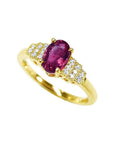 14k yellow gold ring with a deep red oval ruby and sparkling side diamonds.
