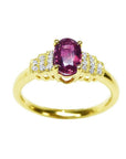 14k yellow gold women's ring with a deep red oval cut ruby and sparkling side diamonds.