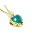 18k yellow gold heart pendant with a bluish-green emerald haloed by diamonds on a delicate chain.