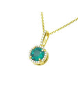 0.88 ct. round cut Colombian emerald pendant necklace with halo diamonds in 14K gold.