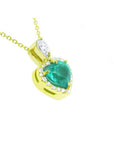 14K yellow gold heart pendant with a deep green emerald and diamond halo.