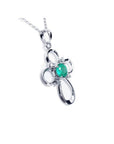 14K white gold cross pendant with a round natural Colombian emerald and diamond accents.
