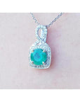 A 18k white gold pendant with a natural round cut colombian emerald from the Muzo mines.