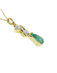 14K gold butterfly pendant with a pear-shaped emerald and pavé diamonds.