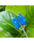 Matching pair of pear-shaped Australian opal doublets with deep blue-green flashing colors.