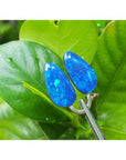 Matching pair of pear-shaped Australian opal doublets with deep blue-green flashing colors.