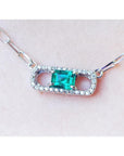 18K white gold paper clip necklace with a vibrant emerald and diamond pendant.
