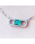 18K white gold paper clip necklace with a vibrant emerald and diamond pendant.