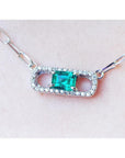 18K white gold paper clip necklace with a vibrant emerald and diamond pendant.