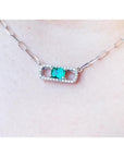 18K white gold paper clip necklace with a vibrant emerald and diamond-studded rectangular pendant.
