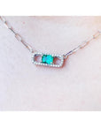 18K white gold paper clip necklace with a vibrant emerald and diamond-studded rectangular pendant.