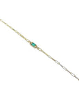 14K yellow gold paper clip bracelet with a rectangular natural emerald and diamond accents.
