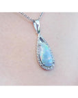 Pear-shaped Australian opal pendant with halo diamonds on an 18K white gold chain.