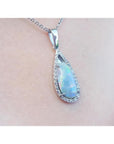Pear-shaped Australian opal pendant with halo diamonds on an 18K white gold chain.