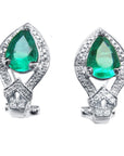 Pair of emerald green teardrop earrings with white gold detailing on a white background