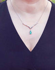 Pear shaped Emerald necklaces pear cut 1.28 carats sourced from Muzo mines encircled by a halo diamond crafted in 14k white gold