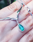 Women's emerald jewelry necklace pear cut sourced from Muzo mines encircled by a halo diamond crafted in 14k white gold