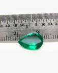1.74-carat pear-cut Colombian emerald, vibrant deep bluish-green, shown next to a ruler.