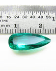 GIA certified Pear shaped loose Colombian emerald, next to a ruler for measuring size