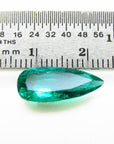 GIA certified Pear shaped loose Colombian emerald, next to a ruler for measuring size