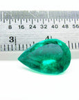 4.17 ct pear-cut natural Colombian emerald with vibrant medium-deep green hue, shown with ruler for scale.