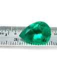 4.17 ct pear-cut natural emerald from Muzo Colombia, vibrant medium-deep green, shown on a ruler.