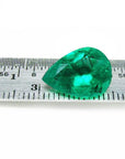 4.17 ct pear-cut natural emerald from Muzo Colombia, vibrant medium-deep green, shown on a ruler.