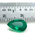 1.84 carat pear-cut natural Muzo Colombian emerald, vibrant bluish-green, shown with a ruler for scale.