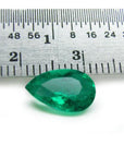 1.84 carat pear-cut natural Muzo Colombian emerald, vibrant bluish-green, shown with a ruler for scale.