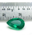 1.84 carat pear-cut natural Muzo Colombian emerald, vibrant bluish-green, shown with a ruler for scale.