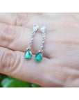 1.05 ct. pear-shaped emerald drop earrings in 14K white gold with diamond accents.