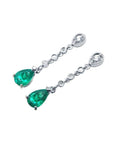 14K white gold pear-shaped emerald drop earrings with diamond accents.