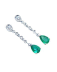 Pear shaped emerald drop earrings in 14k white gold, right position top view