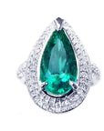 An emerald ring, pear shaped green gemstone held by three prong set, encircled by double halo diamond, in 14k white gold.