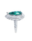 Pear-shaped 3.35 ct. emerald engagement ring in 14K white gold with diamond halo and pavé band.