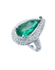 Pear-shaped 3.35 ct. emerald engagement ring in 14K white gold with diamond halo and pavé band.