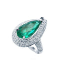 Pear-shaped 3.35 ct. emerald engagement ring in 14K white gold with diamond halo and pavé band.
