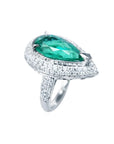 Pear-shaped 3.35 ct. emerald engagement ring in 14K white gold with diamond halo.