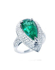 Pear-shaped 3.35 ct. emerald engagement ring in 14K white gold with diamond halo and pavé band.