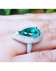 Pear-shaped 3.35 ct. emerald engagement ring in 14K white gold with diamond halo.